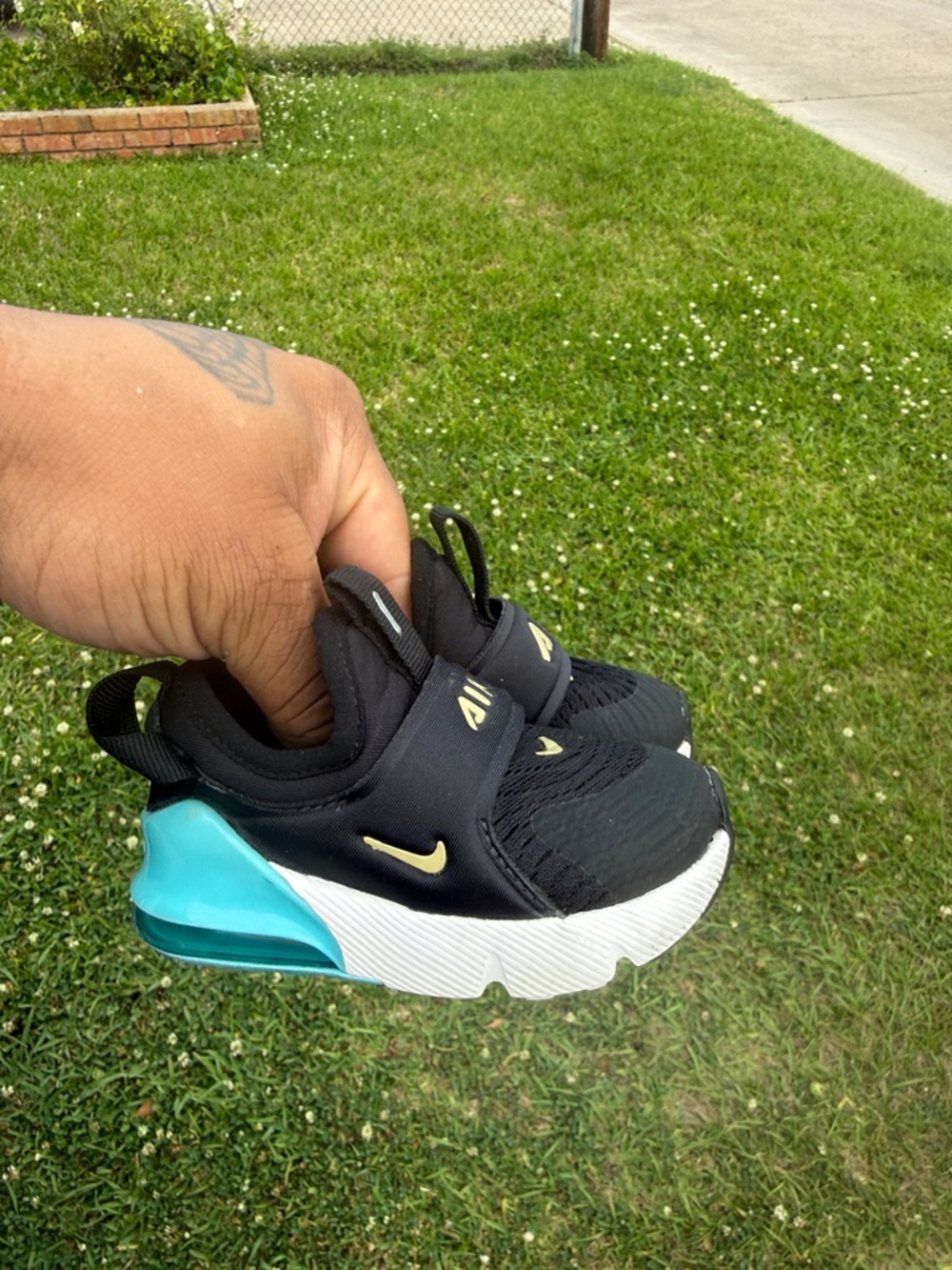 Nike Kids Black Sneakers with Teal Heel and Gold Swoosh